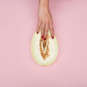 person holding sliced of green fruit