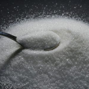 a spoon full of sugar on top of a table