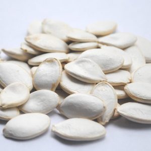 brown almond nuts on white surface