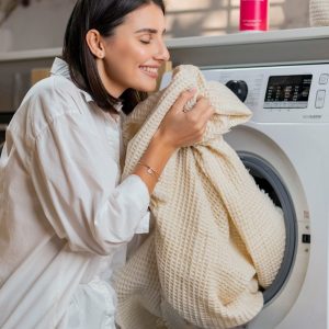a woman is sitting on a washing machine